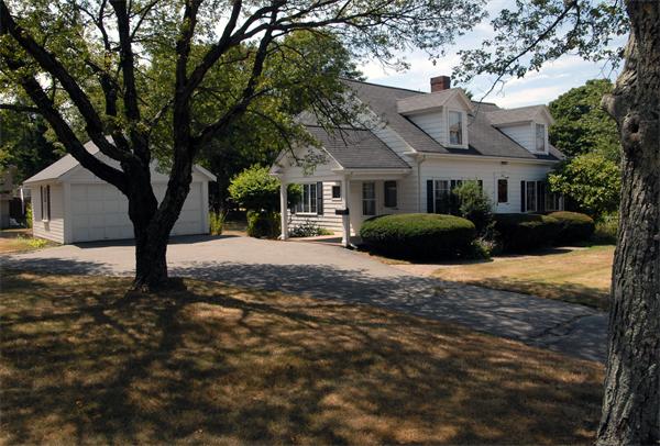 676 Marrett Road Lexington, MA 02421 - Photo 1 of 1 a front view of a house with a yard and garage
