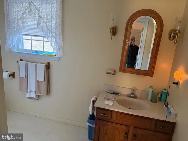 a bathroom with a shower curtain and a sink