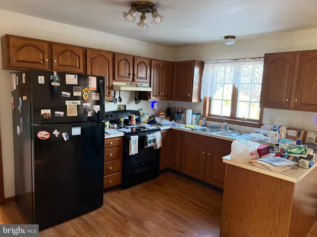 a kitchen with stainless steel appliances granite countertop a refrigerator sink and cabinets