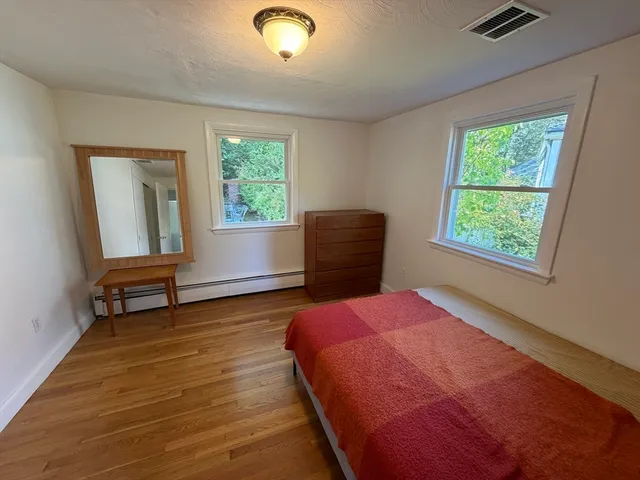 a bedroom with a bed and a chair