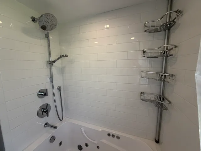 a bathroom with a bathtub and a shower