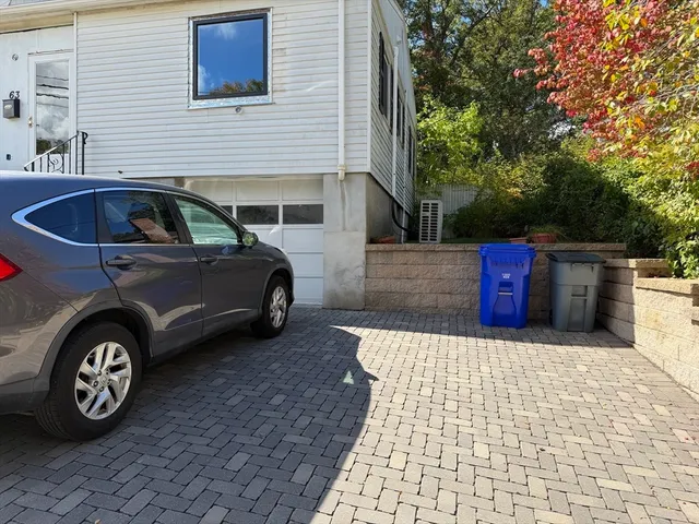 a view of a car parked in front of a house