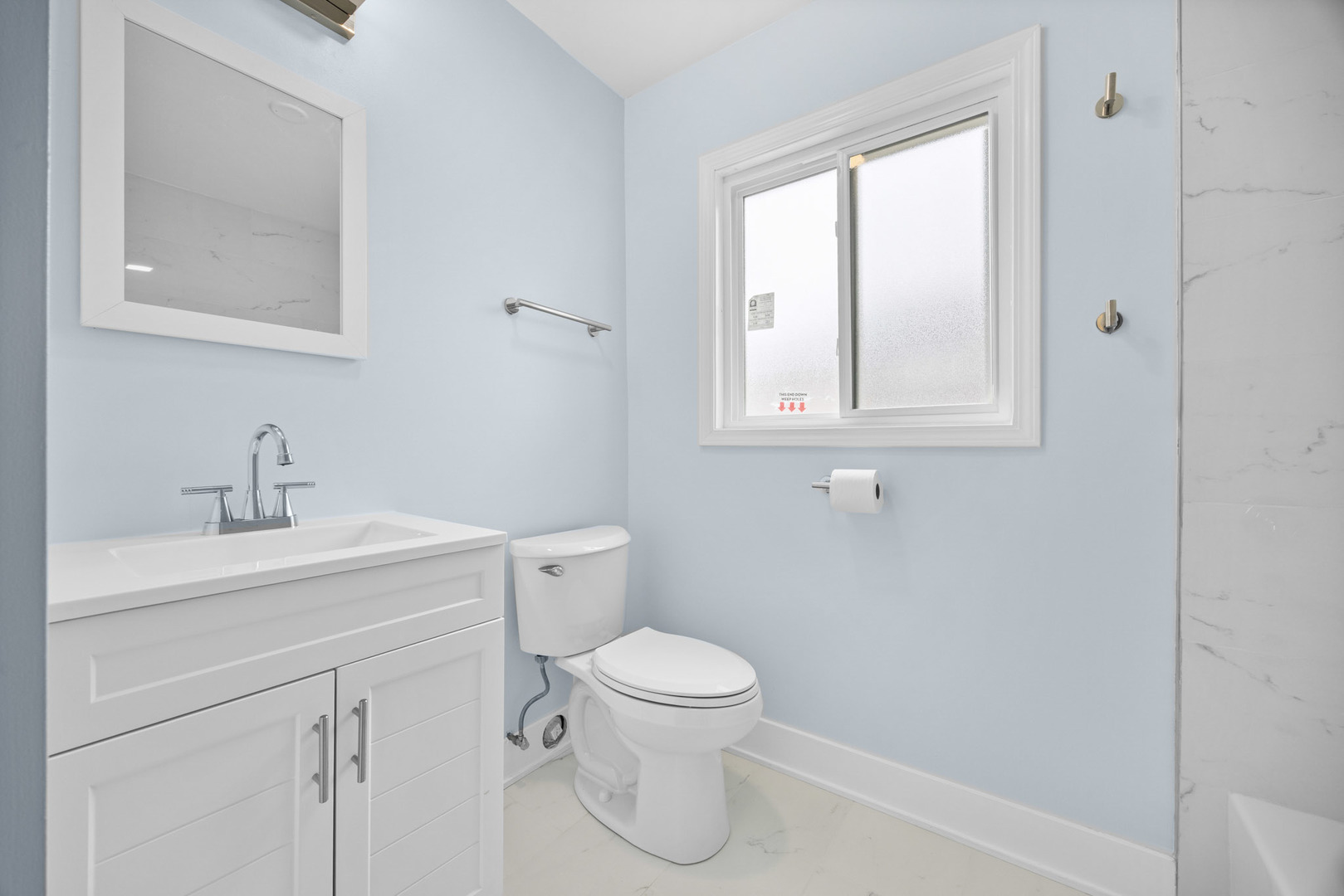1415 North Taft Avenue Berkeley, IL 60163 - Photo 12 of 24 a bathroom with a toilet a sink a vanity and mirror