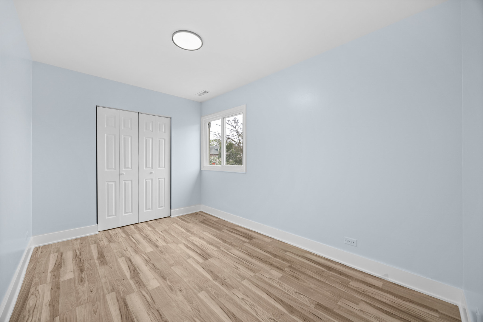 1415 North Taft Avenue Berkeley, IL 60163 - Photo 17 of 24 a view of an empty room with wooden floor and a window