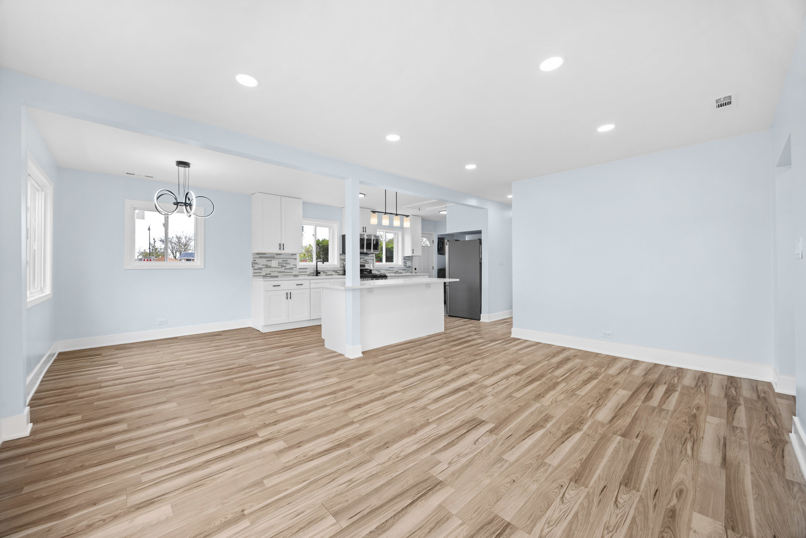 1415 North Taft Avenue Berkeley, IL 60163 - Photo 5 of 24 a view of a kitchen with a sink and wooden floor