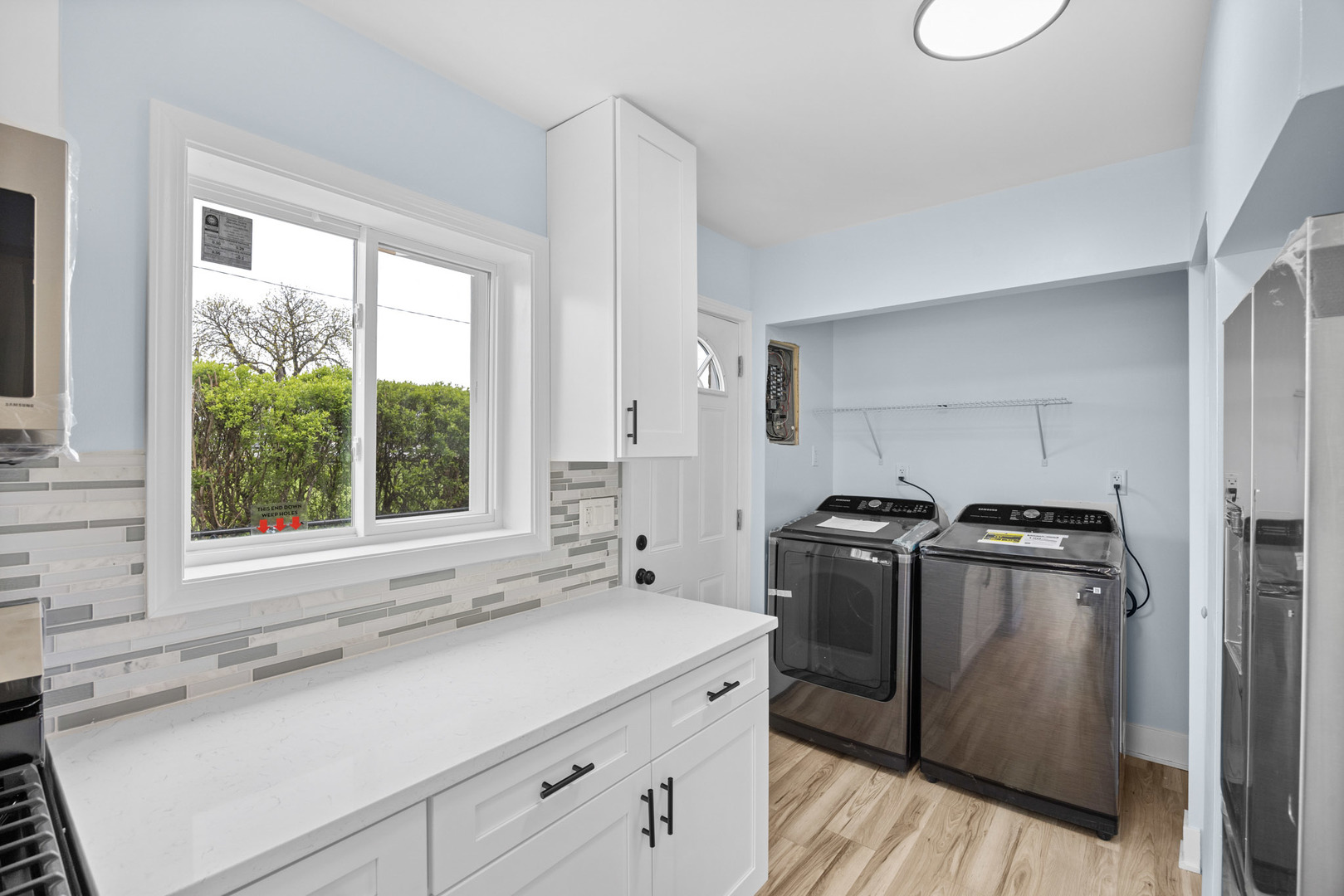 1415 North Taft Avenue Berkeley, IL 60163 - Photo 9 of 24 a kitchen with a stove a sink and a window
