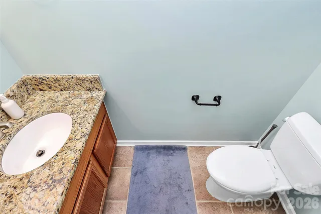 a bathroom with a sink mirror vanity and toilet