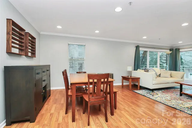 a dining room with furniture and wooden floor
