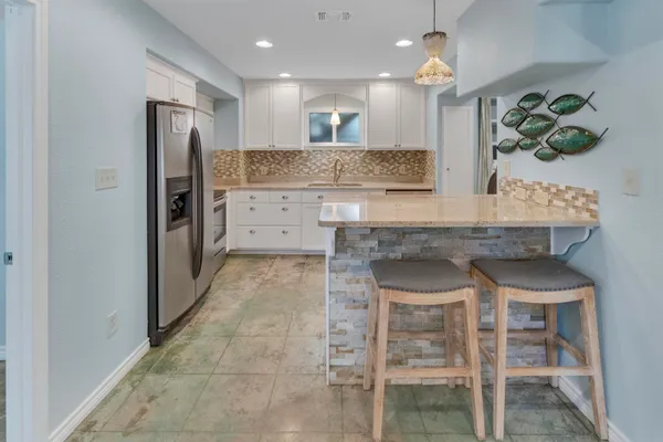 a kitchen with a table and chairs in it