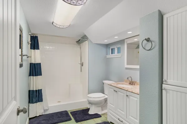 a bathroom with a toilet sink and shower