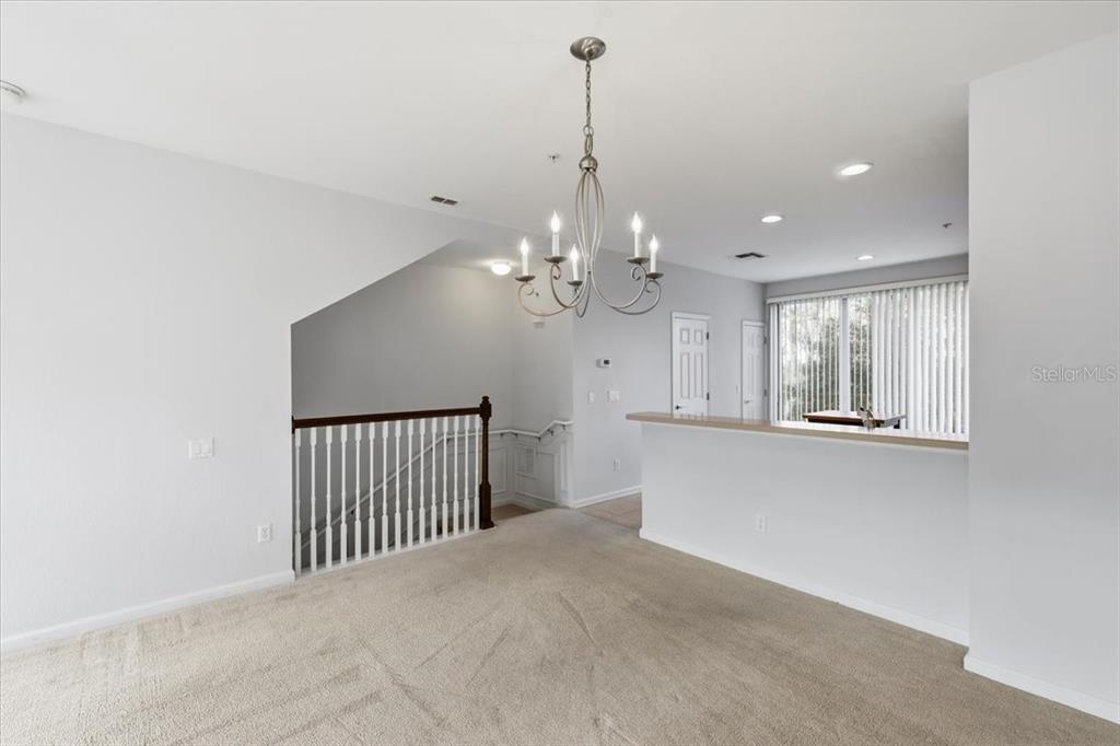 5026 Tideview Circle, Unit 12 Orlando, FL 32819 - Photo 17 of 41 a view of a livingroom with a chandelier fan