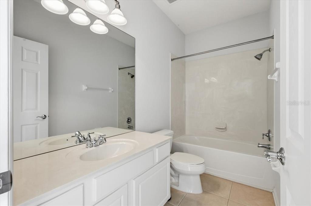 5026 Tideview Circle, Unit 12 Orlando, FL 32819 - Photo 35 of 41 a bathroom with a sink toilet tub and shower