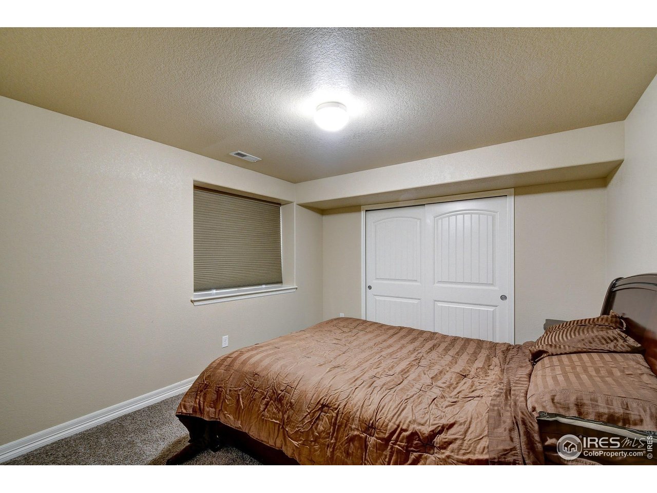 6743 Sequoia Street Frederick, CO 80530 - Photo 27 of 39 a bedroom with a bed and a window