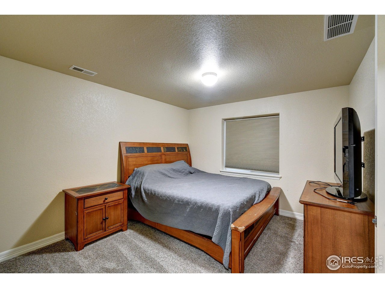 6743 Sequoia Street Frederick, CO 80530 - Photo 29 of 39 a bedroom with a bed and a television
