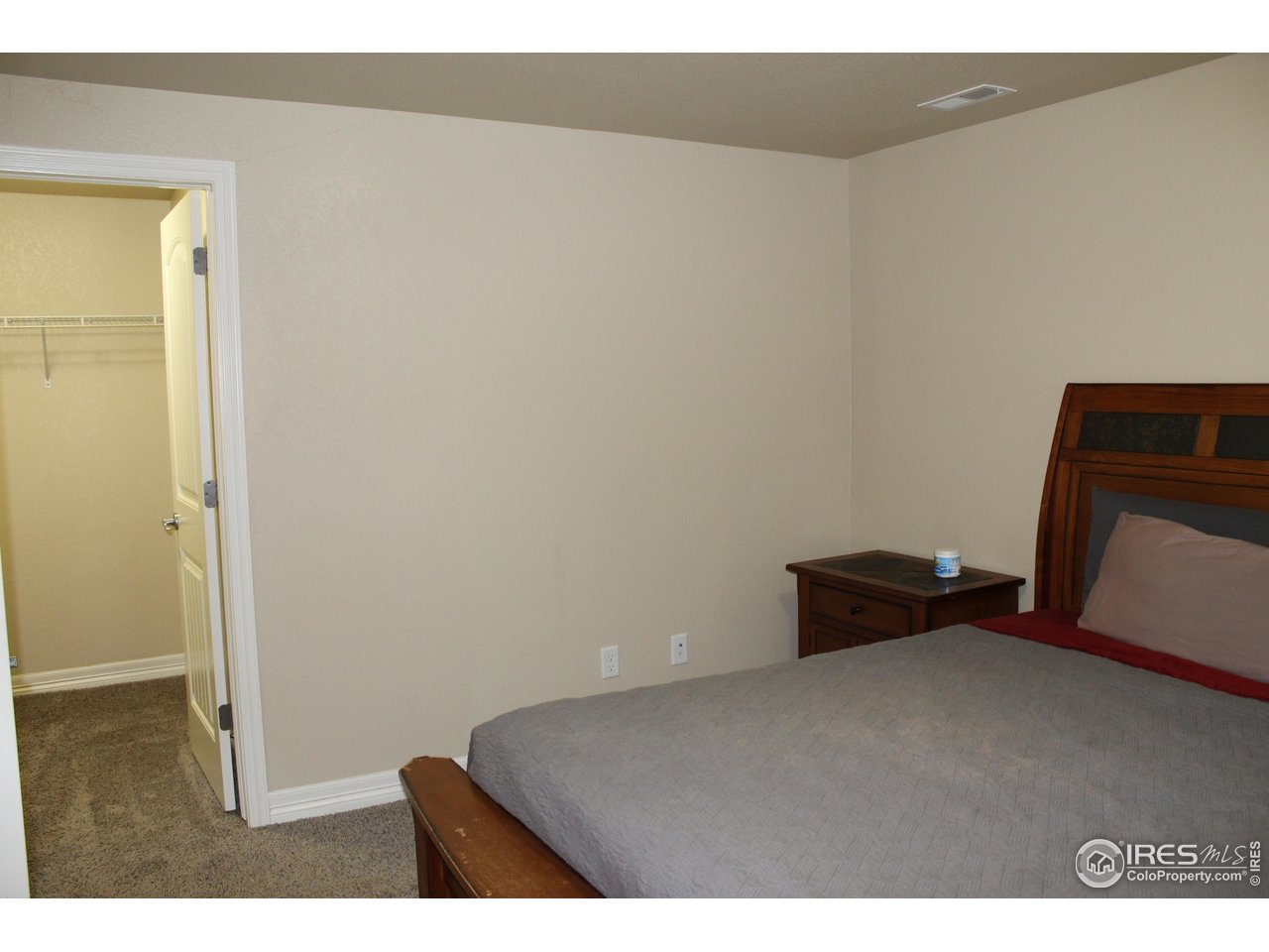 6743 Sequoia Street Frederick, CO 80530 - Photo 30 of 39 a bedroom with a bed and mirror