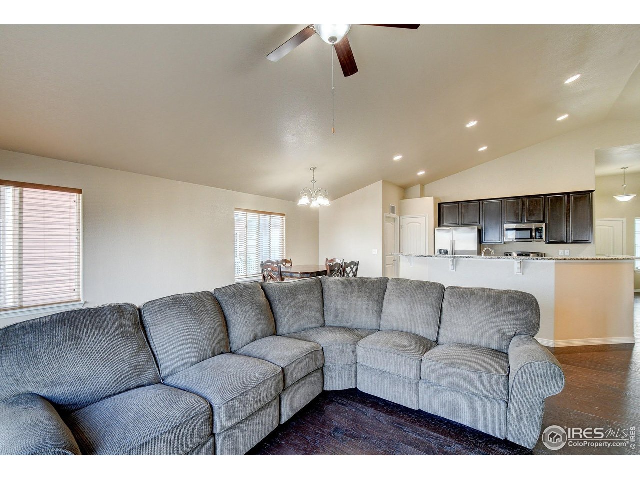 6743 Sequoia Street Frederick, CO 80530 - Photo 10 of 39 a living room with furniture and kitchen view