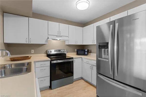 a kitchen with a stove sink and refrigerator