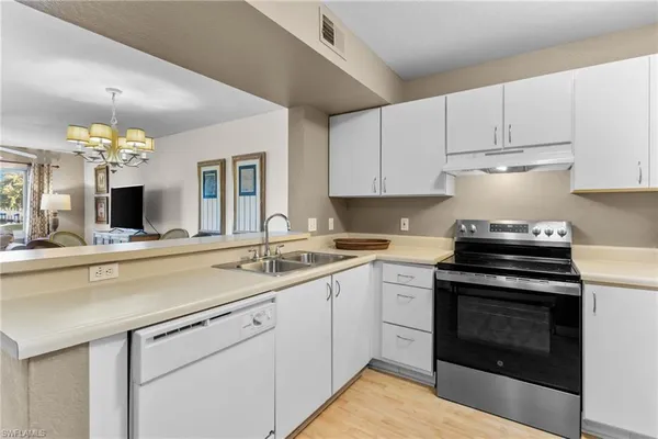 a kitchen with a sink stove and cabinets