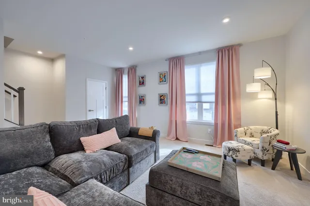 a living room with furniture and large windows