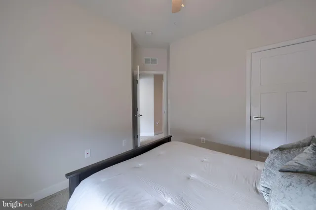 a bedroom with a bed and a mirror