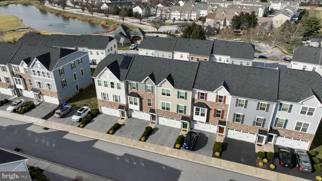 an aerial view of multiple houses with yard