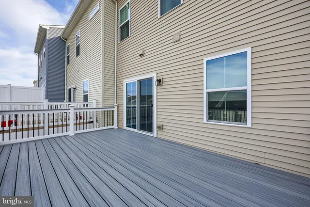 a view of a house with wooden deck