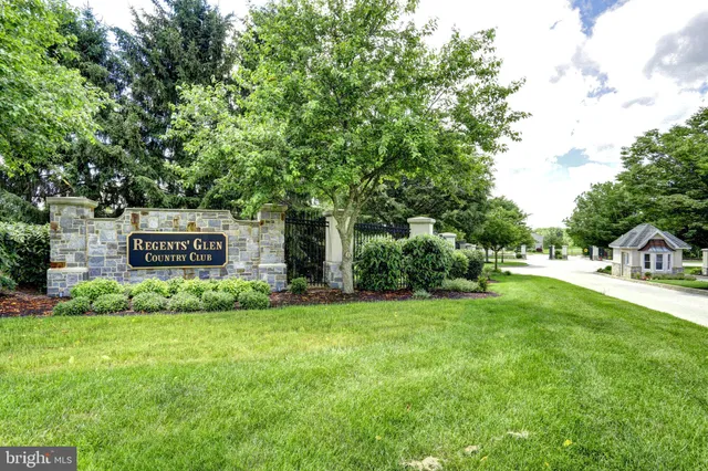 a yard with lots of green space and trees