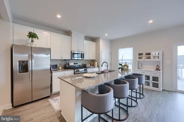 a kitchen with refrigerator and cabinets