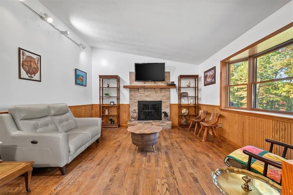 140 Curry Road Burgettstown, PA 15021 - Photo 6 of 25 a living room with furniture fireplace and a flat screen tv