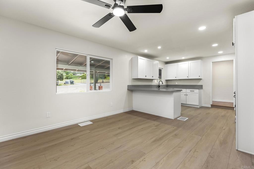 13500 Jamul Drive Jamul, CA 91935 - Photo 14 of 39 an open kitchen with kitchen island white cabinets and stainless steel appliances