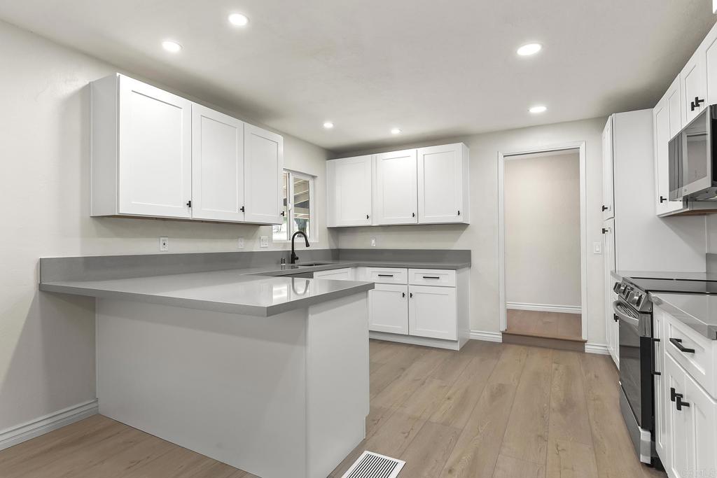 13500 Jamul Drive Jamul, CA 91935 - Photo 15 of 39 a kitchen with stainless steel appliances granite countertop a sink stove and refrigerator