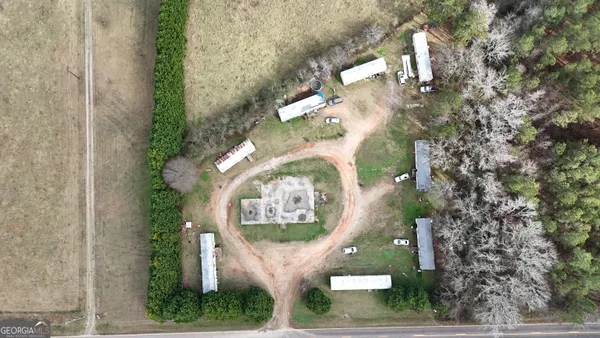 an aerial view of a house with a yard and trees