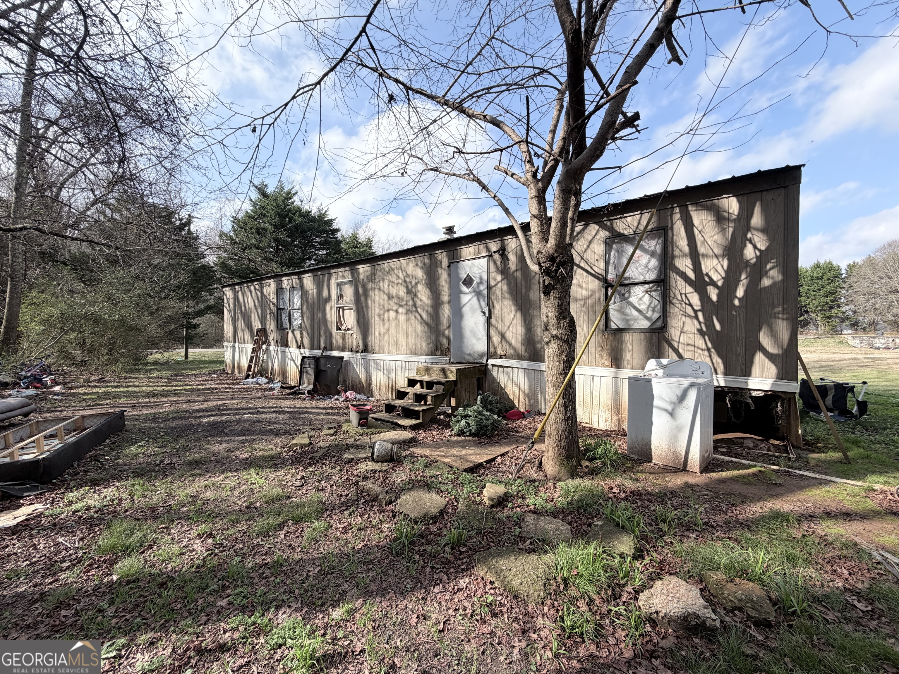 4334 Log Cabin Road Southwest White Plains, GA 30678 - Photo 16 of 20 a view of backyard with large trees and wooden fence