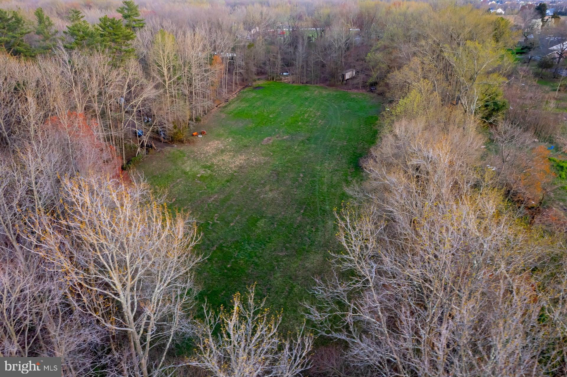 121 Moods Road Mullica Hill, NJ 08062 - Photo 6 of 22 a view of a yard with plants and a bench