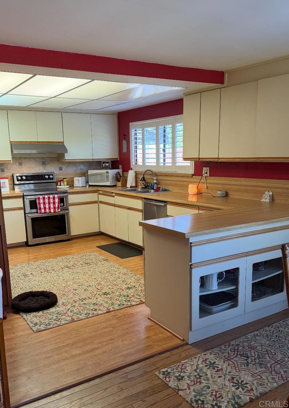 9168 Old Castle Road Valley Center, CA 92082 - Photo 7 of 14 a kitchen with stainless steel appliances granite countertop a stove a sink and a microwave
