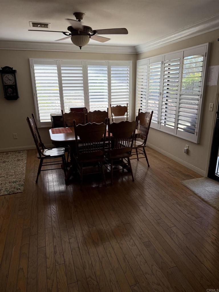 9168 Old Castle Road Valley Center, CA 92082 - Photo 8 of 14 a view of a dining room with furniture window and wooden floor