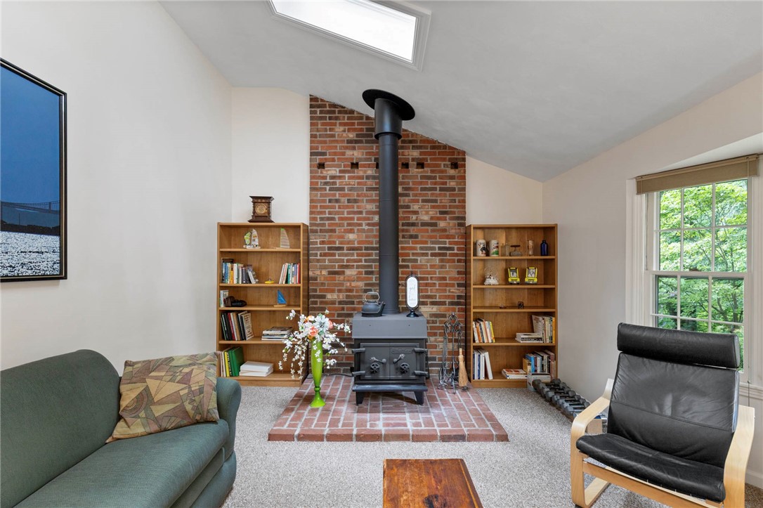 693 Ashdon Circle Webster, NY 14580 - Photo 19 of 50 Family room with wood-burning stove