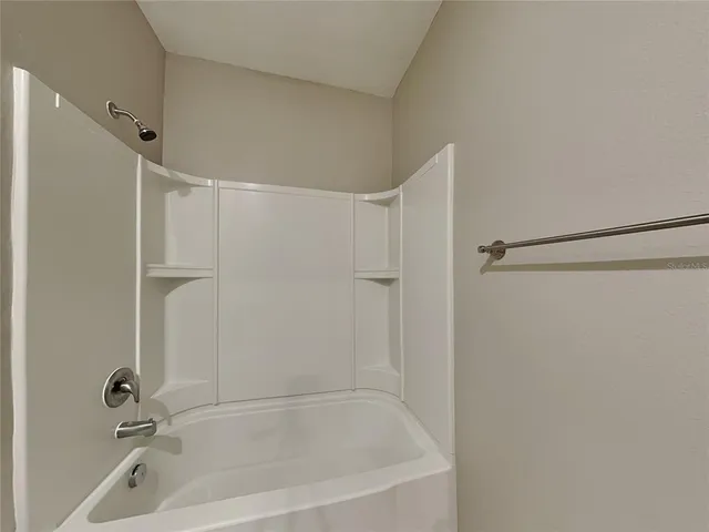 a bathroom with a shower and a bath tub