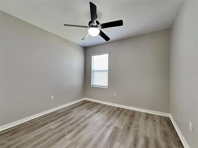 a view of room with window and ceiling fan