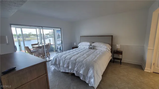 a bedroom with a bed and glass door