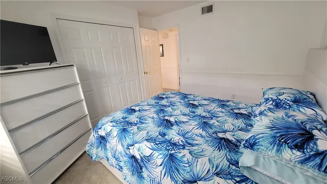 a bedroom with a bed and flat screen tv