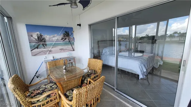 a living room with furniture and a floor to ceiling window