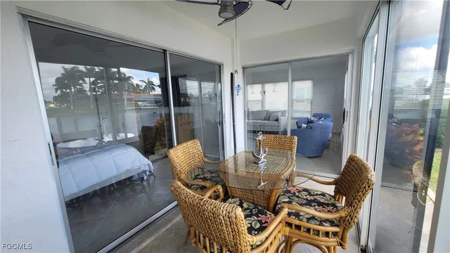 a dining room with furniture and a floor to ceiling window