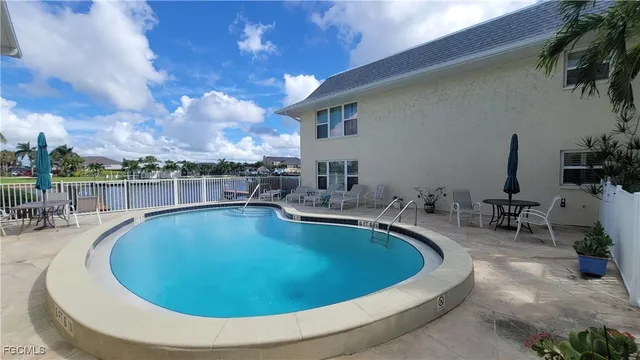 a view of a swimming pool with outdoor seating