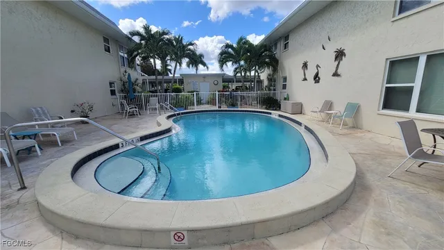 a view of a swimming pool with outdoor seating