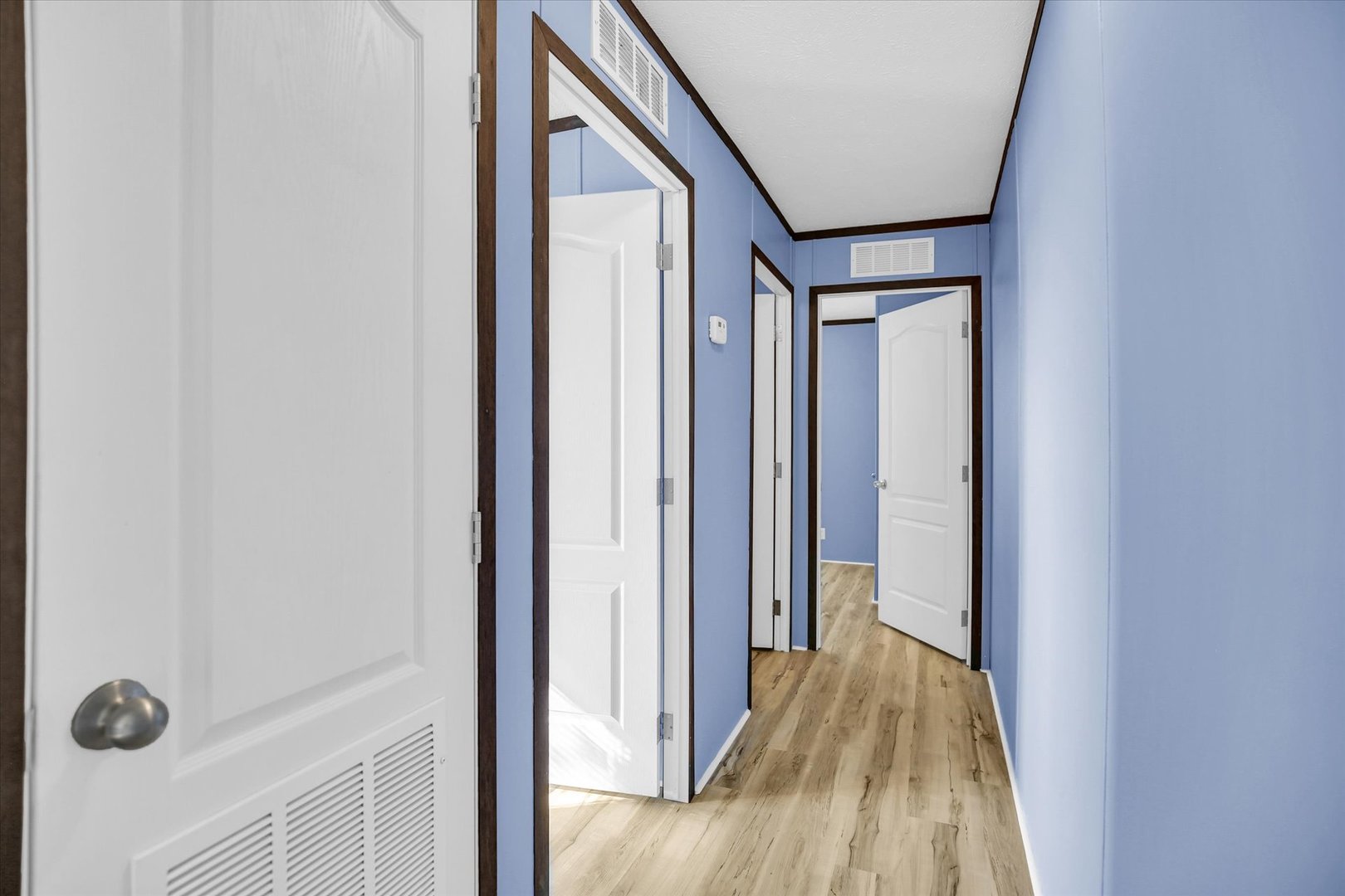 1216 Sycamore Lane Rantoul, IL 61866 - Photo 15 of 26 a view of a hallway with wooden floor and a bathroom