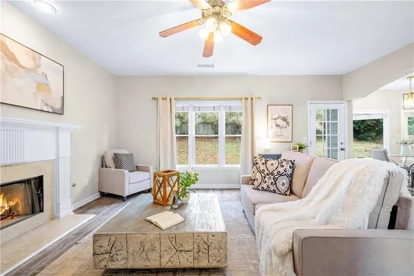 a living room with furniture a fireplace and a flat screen tv
