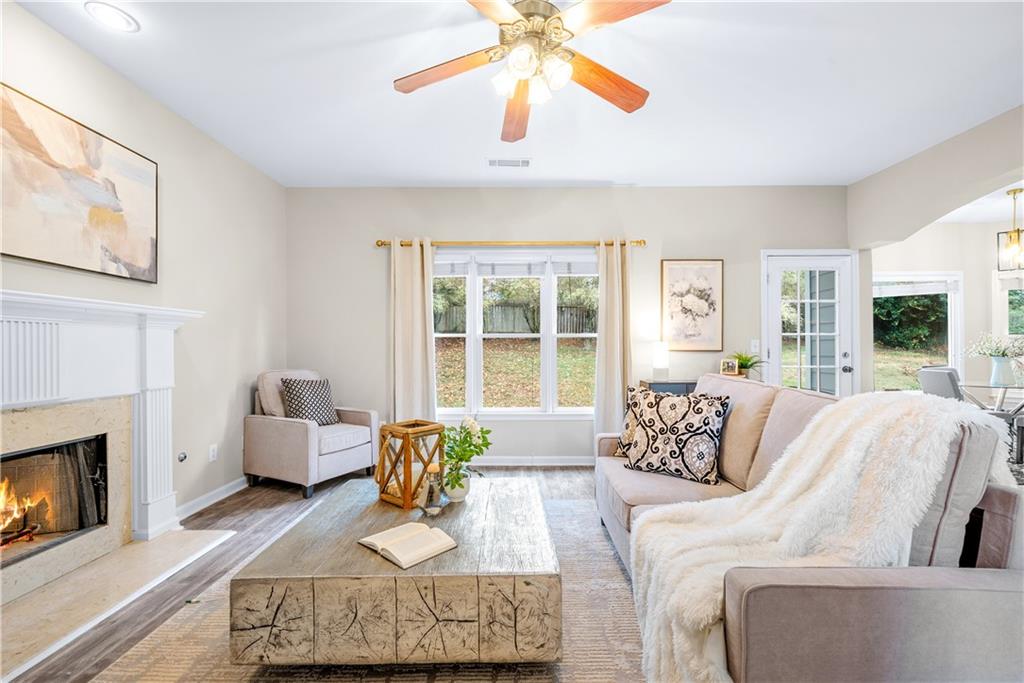 3720 Brookefall Landing Suwanee, GA 30024 - Photo 14 of 41 a living room with furniture and a fireplace