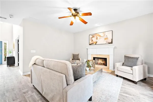 a living room with furniture and kitchen view