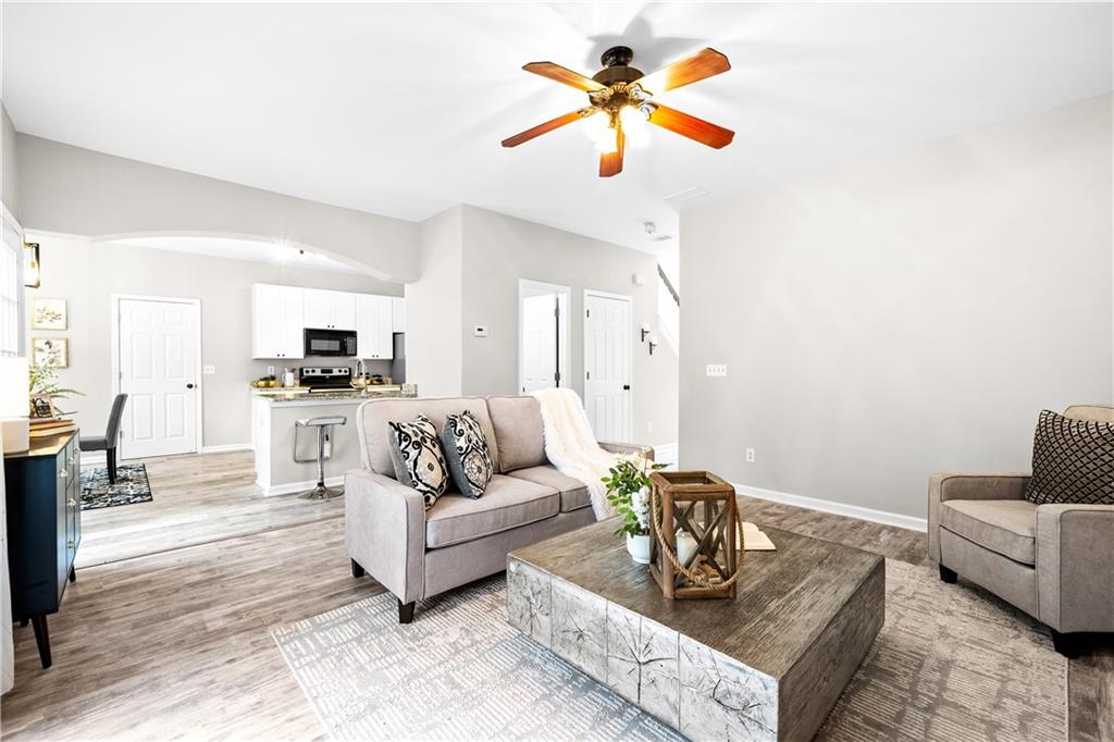 3720 Brookefall Landing Suwanee, GA 30024 - Photo 16 of 41 a living room with furniture and kitchen view